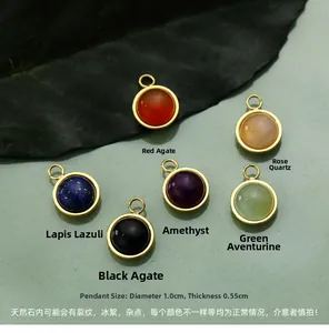 Detail of round natural stone pendants with gold metal edges and varied gemstone colors