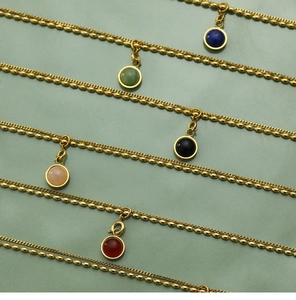 Detailed view of layered 18K gold-plated rice bead chains with multi-color agate pendants