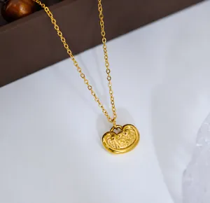 Detailed view of the vintage gold longevity lock pendant with intricate clouds pattern