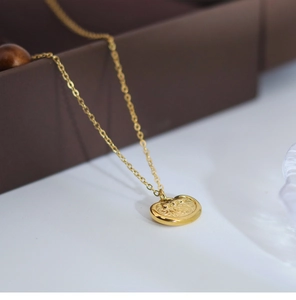 Macro shot of gold vintage longevity lock necklace with traditional Chinese patterns