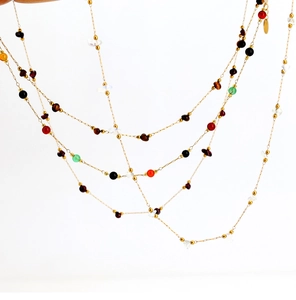 Close-up of layered bohemian necklace with colorful semi-precious beads and 18K gold chain
