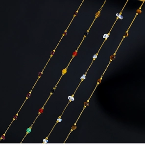 Macro detail of 18K gold plated necklaces featuring irregular amethyst and natural tiger eye stones