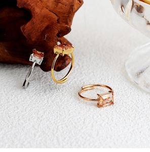 Three champagne zircon rings in gold silver and rose gold finishes on wood