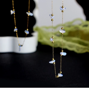 Detailed close-up of blue moonstone chips on a 18K gold plated chain with small gold beads