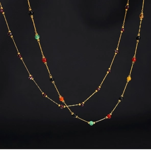 Macro detail of natural multi-gemstone beads on a 18K gold-plated irregular stone necklace