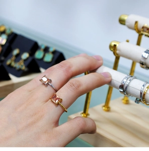 Detail shot of gold and silver plated rings featuring rectangular orange zircon stones