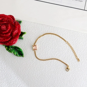 Minimalist gold stainless steel bracelet featuring a rectangular champagne zircon gemstone