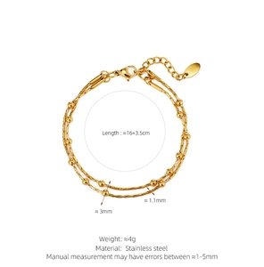 Detailed view of gold double-layer snake chain bracelet with polished beads and extender