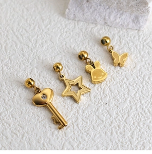 Detailed view of gold plated stainless steel charms including key, star, rabbit and butterfly