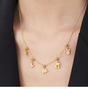 Detail of gold-plated stainless steel necklace with five cute animal and heart pendants