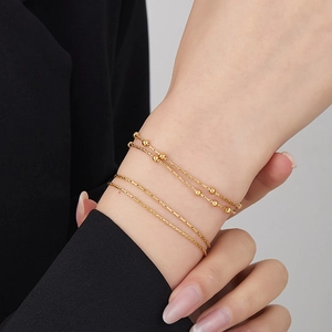 Double-layered snake chain bracelet with golden beads in 18K gold plated titanium steel