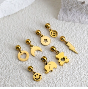 Macro view of gold stainless steel charms including stars, moon, and heart shapes