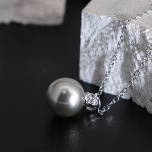 Classic silver-tone chain necklace with a gray pearl pendant and sparkling zircon stone