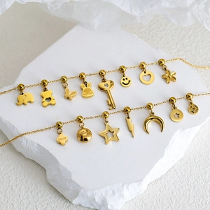Gold stainless steel chain featuring assorted charms like elephant, bear, and moon