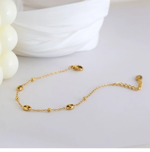 Close-up of gold beaded coffee bean chain bracelet with lobster clasp and extender