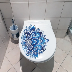 Detailed view of the blue mandala flower pattern on a white self-adhesive toilet seat cover