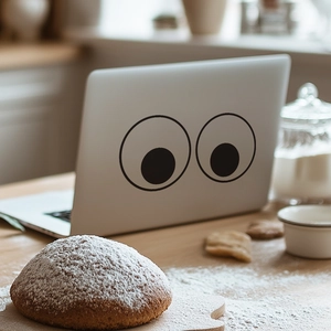 Minimalist big eyes toilet sticker or laptop decal on silver grey surface in cozy kitchen