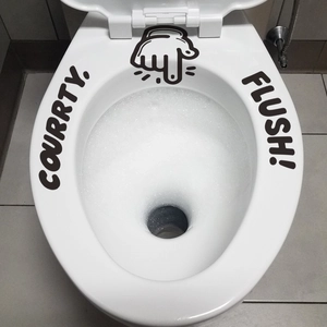 Waterproof black 'Flush' lettering and hand gesture sticker on a white ceramic toilet lid