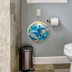 3D porthole ocean wall sticker with dolphins and coral reef in a modern bathroom
