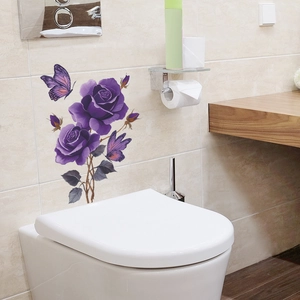 Self-adhesive wall sticker with purple roses and butterflies on a bathroom tile wall