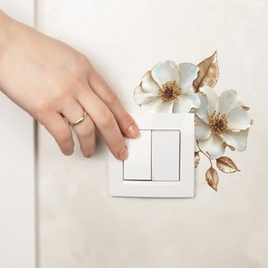 3D floral wall sticker with white flowers and gold leaves around a double light switch