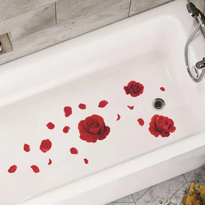 Detailed view of red rose and petal decals applied to a white bathtub surface