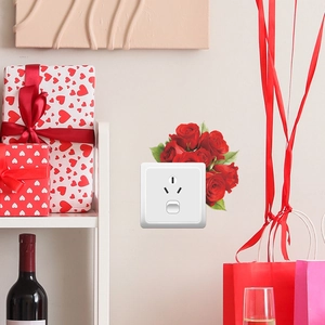 Stickers muraux roses rouges romantiques autour des prises avec boîtes cadeaux festives