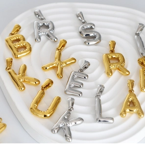 Detailed macro view of 3D balloon-style metal alphabet pendants on white display