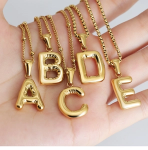Detail of 18K gold plated balloon style alphabet charms with realistic wrinkle texture