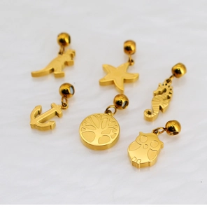 Detailed close-up of six gold-plated DIY charms including dinosaur, seahorse and anchor