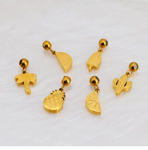 Detailed view of six golden summer charms including pineapple and palm tree for DIY jewelry
