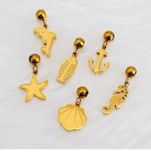 Detailed macro view of 6 gold ocean-themed charms including dolphin and starfish shapes