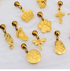 Detailed close-up of golden stainless steel mini charms featuring crown and animal shapes