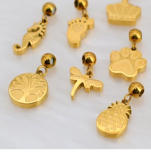 Detailed flat lay of assorted gold-plated DIY charms featuring seahorse and crown motifs