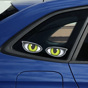Pair of creative fluorescent green animal eye stickers on a blue car window decoration