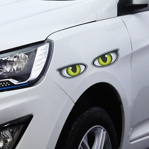 Vibrant green cat eye 3D car stickers for body decoration on a white vehicle surface