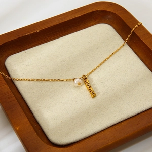Elegant 18k gold plated stainless steel mama necklace with a white pearl pendant