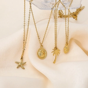Detailed close-up of golden ocean-themed charms including starfish and coconut tree pendants