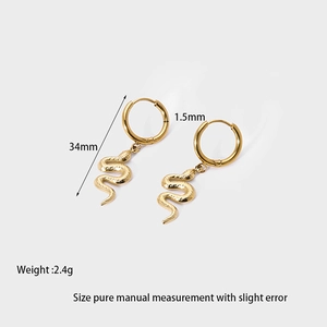 Detail view of 14k gold plated snake drop earrings with scale texture and 34mm dimensions