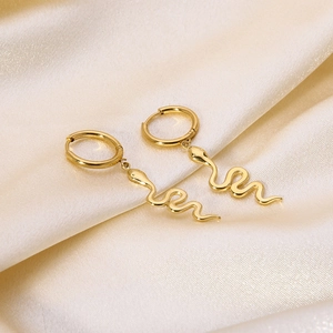 Detail of 14k gold plated stainless steel snake pendant hoop earrings on silk