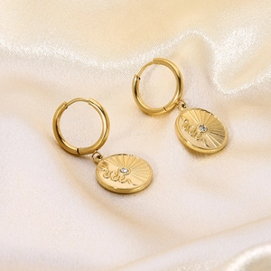 Close-up of 14k gold plated stainless steel earrings with snake pattern on satin cloth