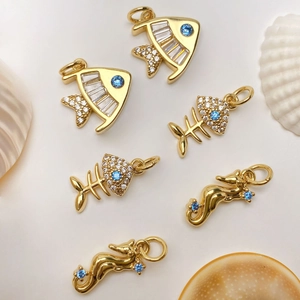 Detailed view of marine charms with micro-pave zircons and seahorse designs