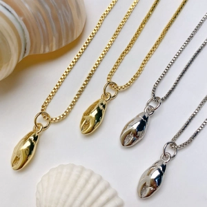 Marine style crab claw pendants on box chains in gold and silver finishes