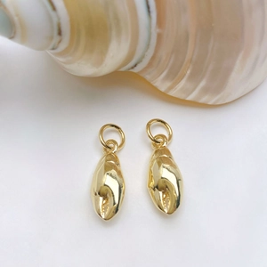 Macro view of gold-plated crab claw pendants with jump rings for DIY jewelry making