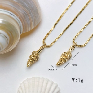 Detailed view of conch shell pendant measuring 15mm by 5mm in gold finish
