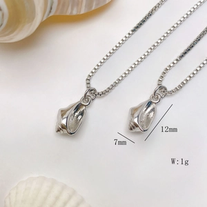 Detail of silver conch pendant necklace showing dimensions 12mm by 7mm and 1g weight