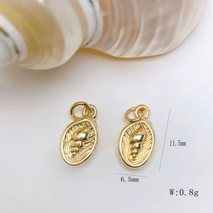 Macro shot of gold oval conch pendant charms with size dimensions 11.5mm x 6.5mm