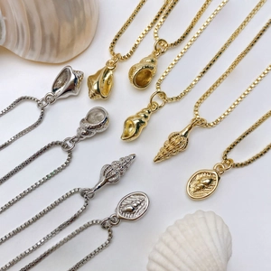 Detailed macro view of marine ocean shell pendants with zircon inlay on box chains