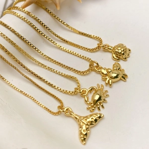 Gold box chain necklaces with nautical pendants including turtle, crab and fishtail motifs