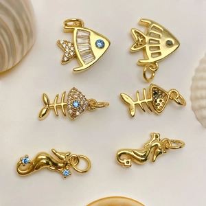 Gold marine pendants featuring cubic zirconia fish and seahorse for jewelry making